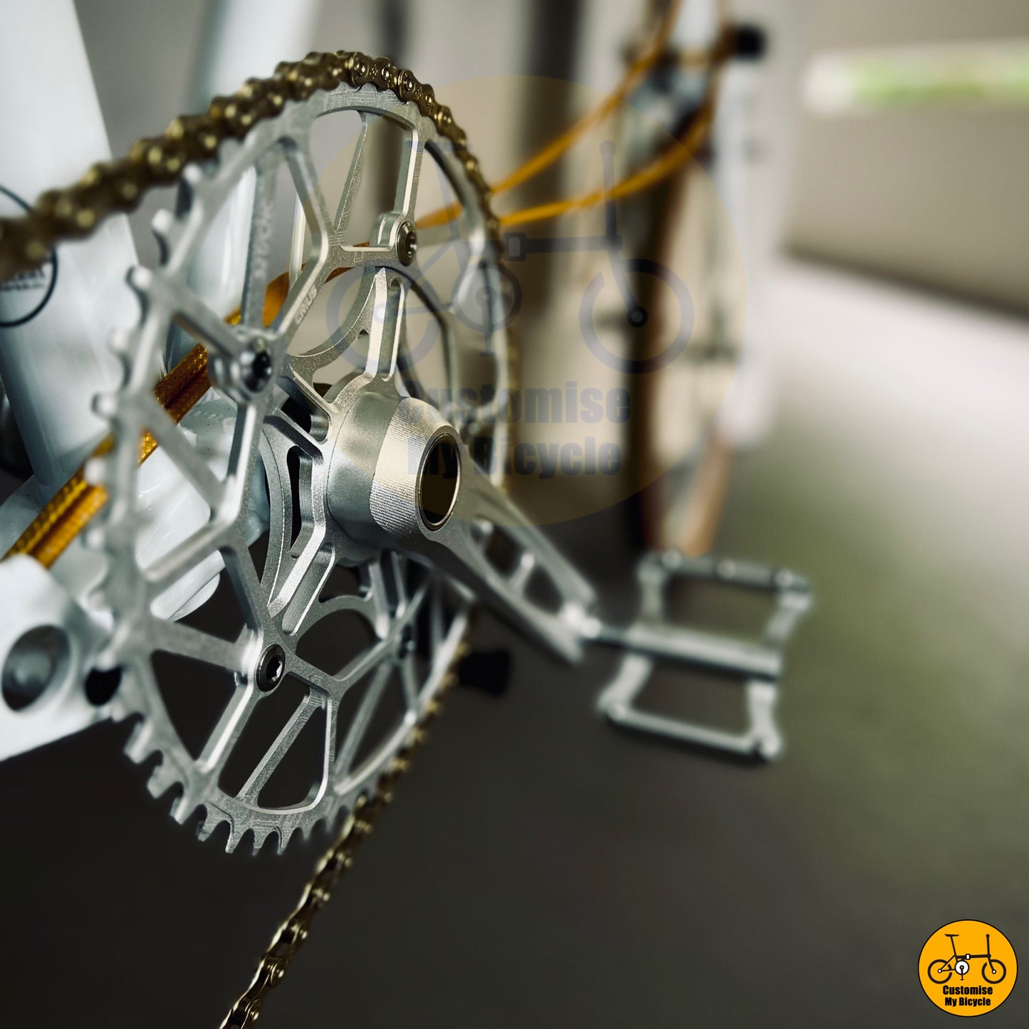 Elegant white foldable bike with precision-crafted chainring and crankset
