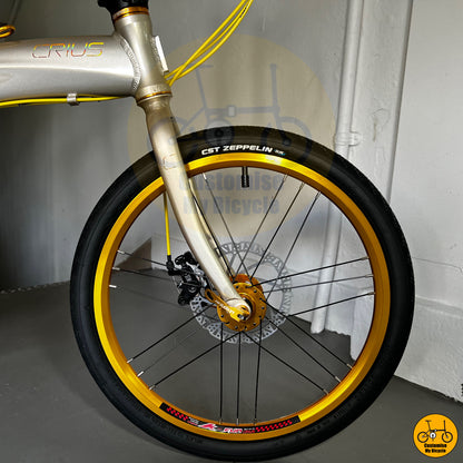 Front wheel and fork of Crius Velocity folding bicycle with CST Zeppelin tires and disc brakes