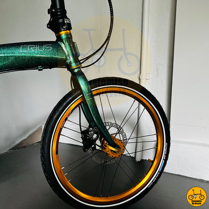Crius Velocity 22-inch folding bike with chameleon green frame and gold wheels
