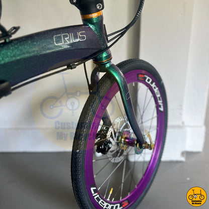 Premium foldable bicycle with purple deep-section wheels and a sleek design

