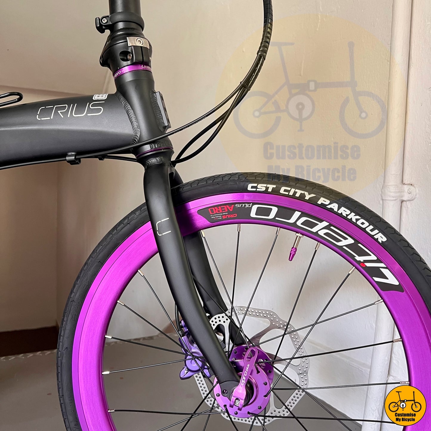 Matte black Crius Velocity 22-inch folding bike with purple deep-section wheels
