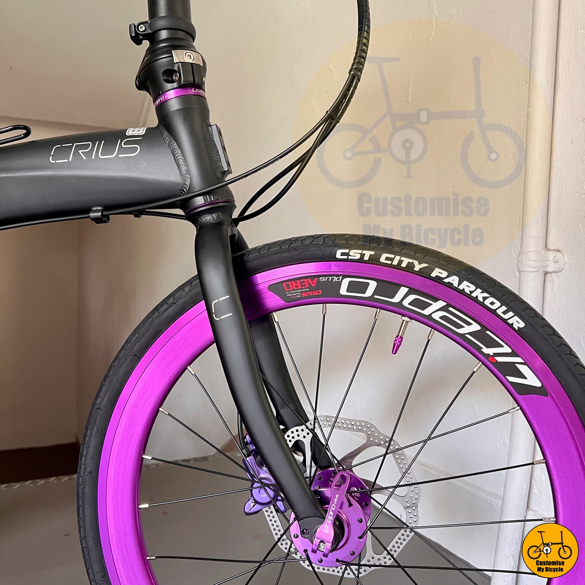 Matte black Crius Velocity 22-inch folding bike with purple deep-section wheels
