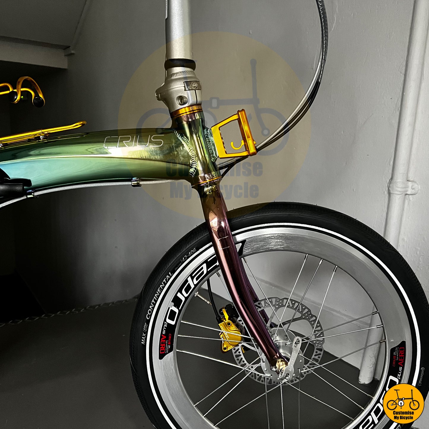 Crius Velocity 20-inch folding bike with an oil slick frame and gold accents
