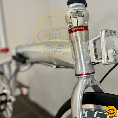 Platinum silver folding bike with a compact and stylish frame
