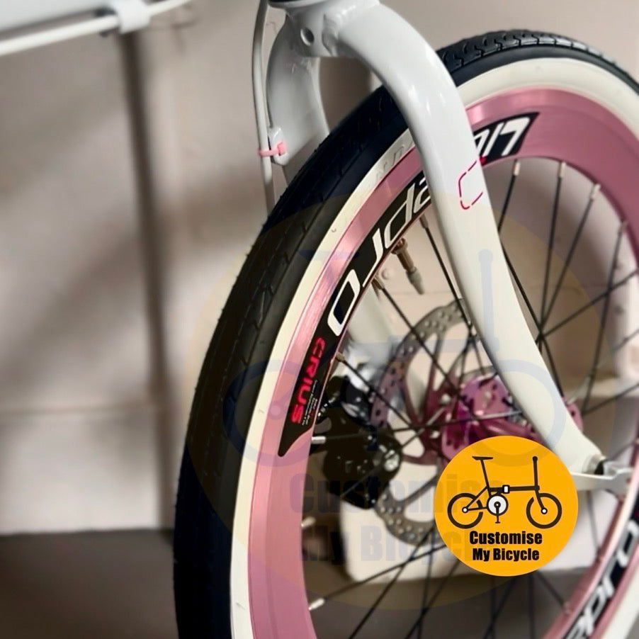 White foldable bike with pink Litepro aero wheels and Shimano gearset  

