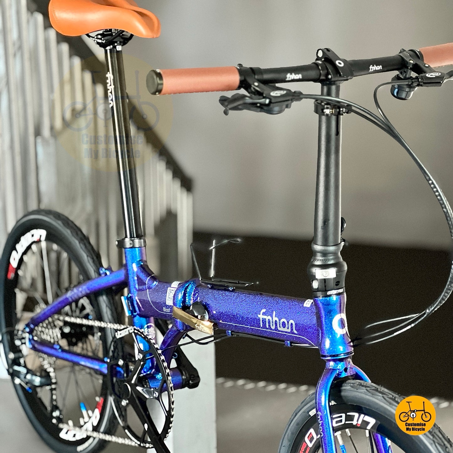 Folding bike with brown retro saddle
