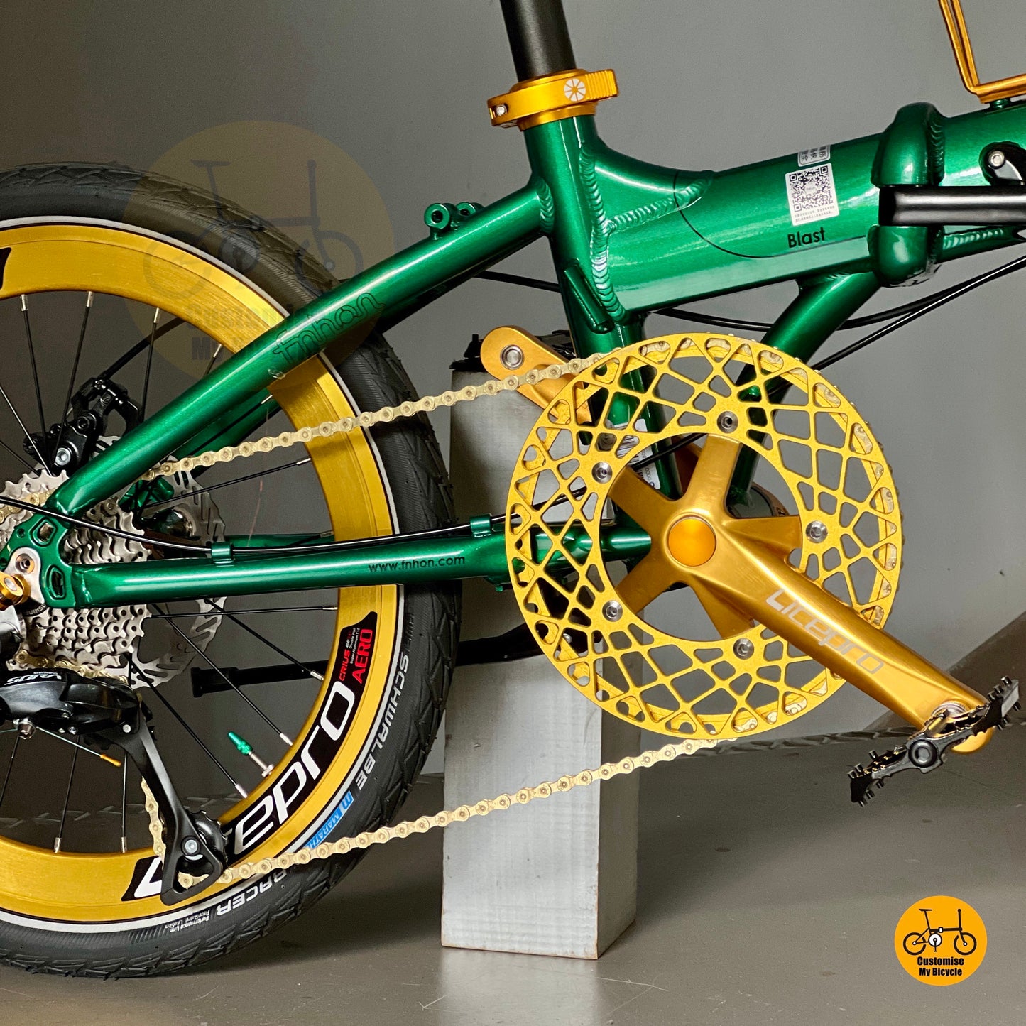 Close up of FNHON/LITEPRO Hollowtech crankset with gold hollow 54t chainring
