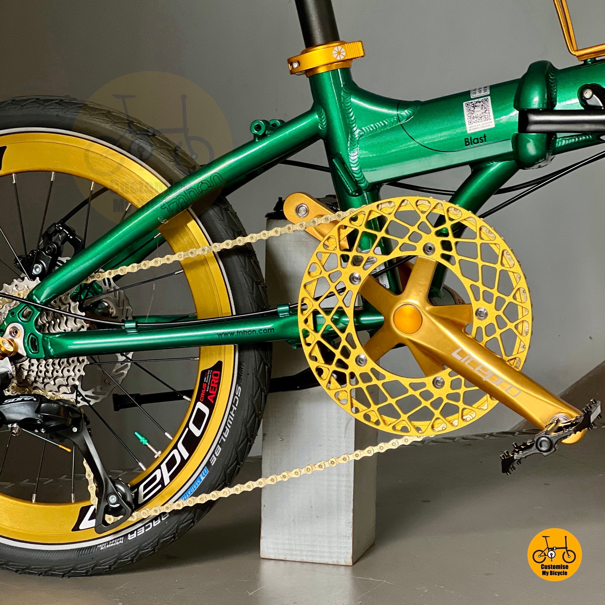 Close up of FNHON/LITEPRO Hollowtech crankset with gold hollow 54t chainring
