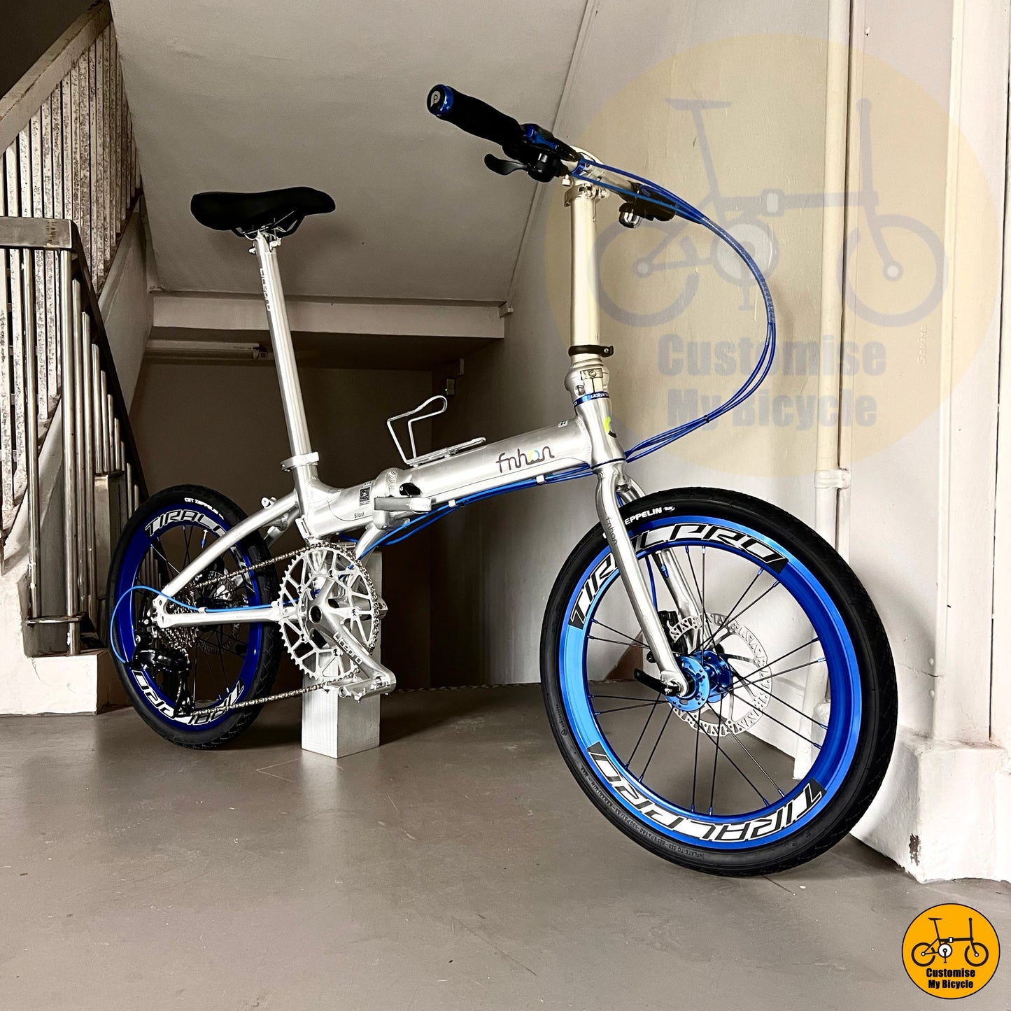 Foldable bike with sleek polished design and blue cabling
