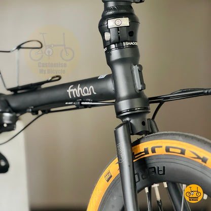 Matte black folding bike front angle view Litepro aero wheels Schwalbe Kojak tan wall tyres
