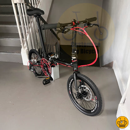 Black folding bicycle frame with red highlights  
