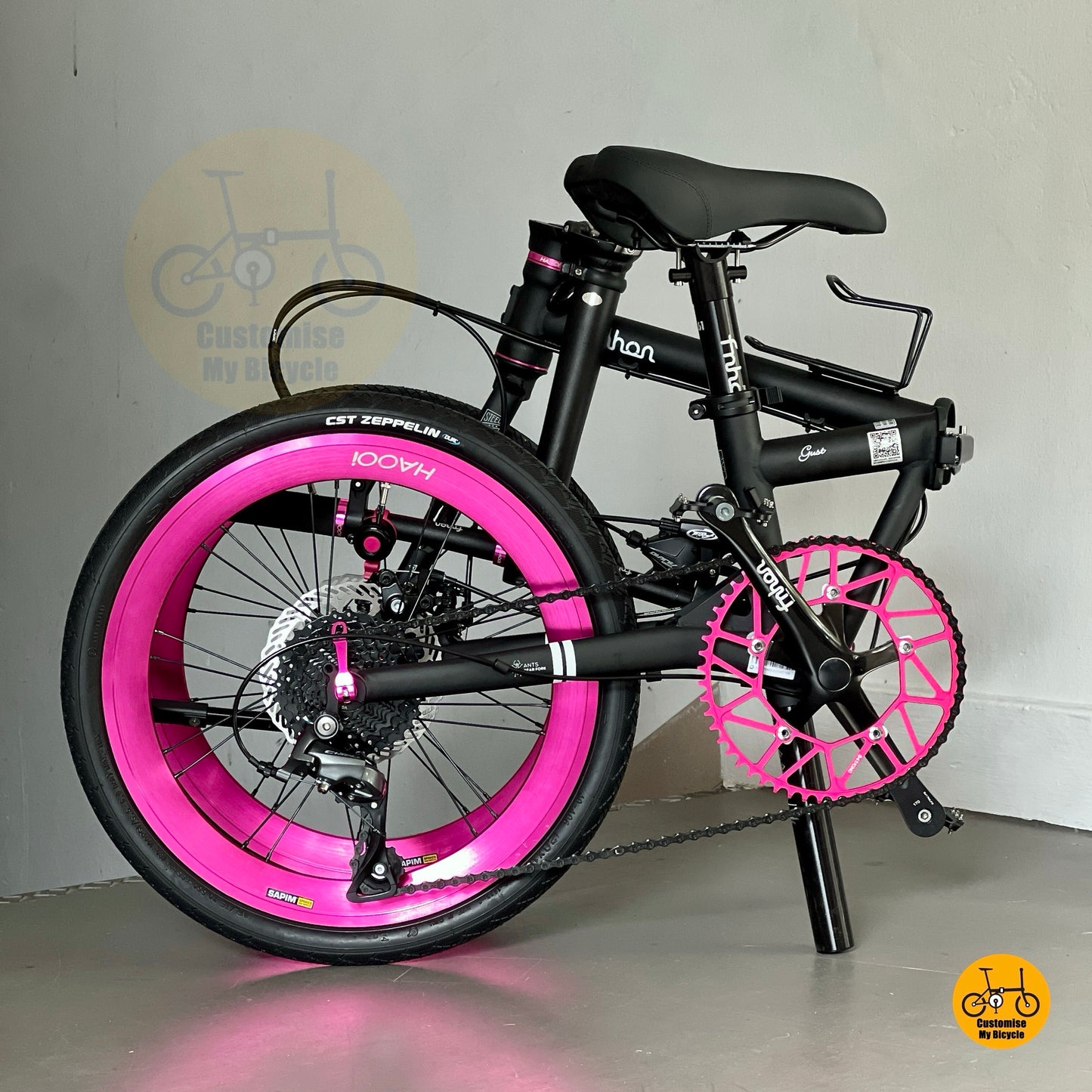 Folded Fnhon Gust matte black bike with pink rims side view for product listing