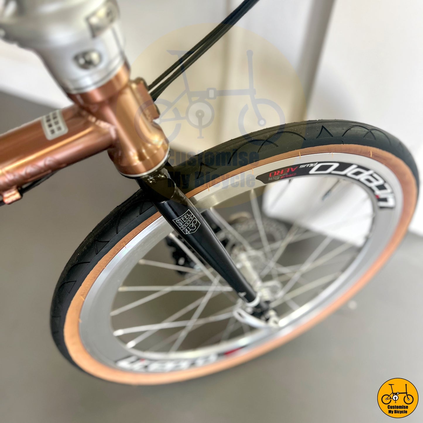 Rose gold Fnhon Gust 20-inch folding bike with brown wall Innova tyres
