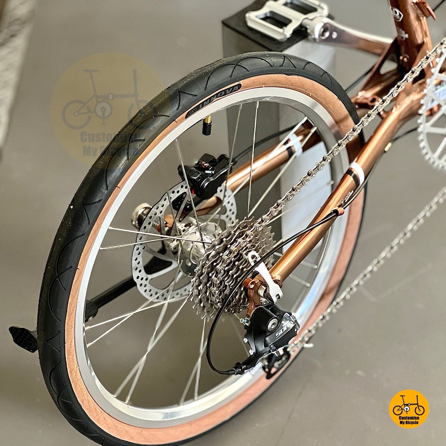 Close up of Shimano 9 speed rear derailleur on rose gold chromoly frame
