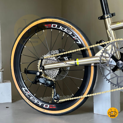 Close-up of Shimano rear derailleur and cassette on Fnhon Gust titanium gold, highlighting drivetrain precision and chain alignment.