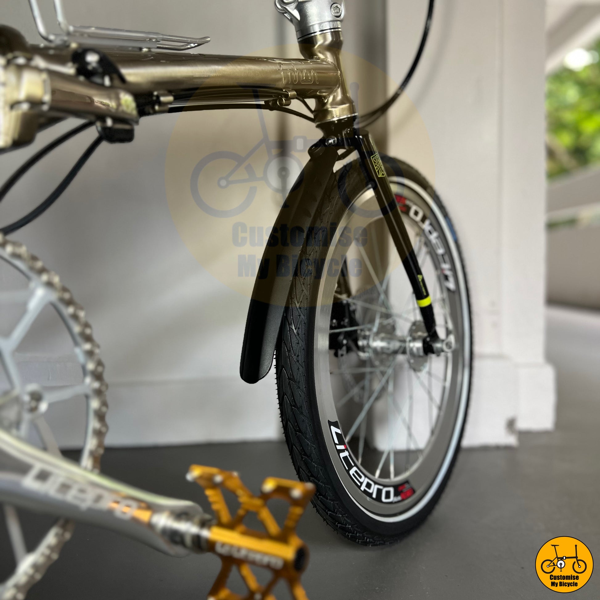 Titanium gold frame folding bike with a timeless aesthetic
