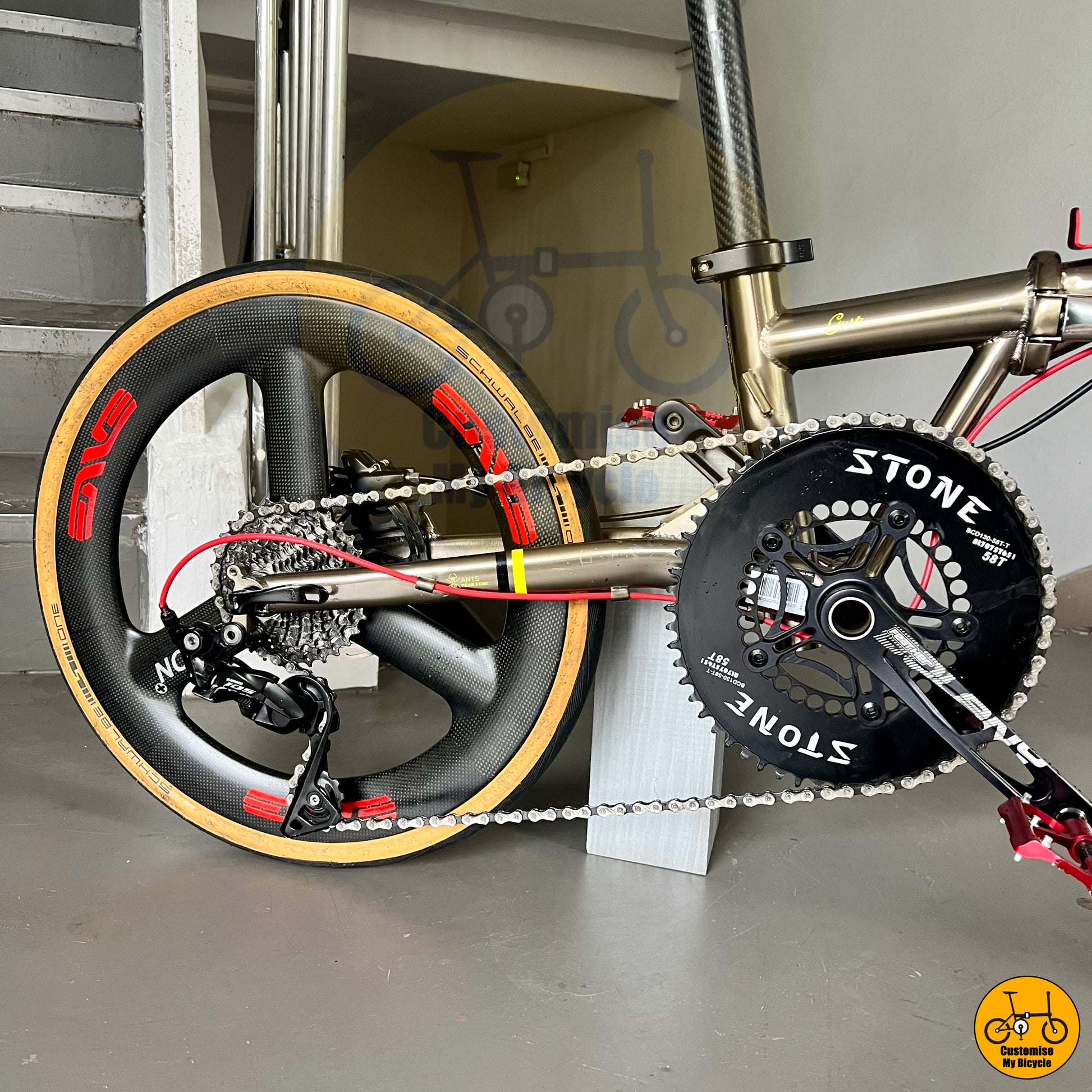 Stone oval chainring on titanium gold frame folding bike with a race-inspired look
