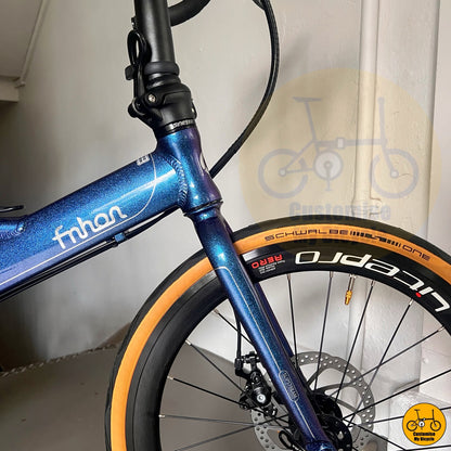 Foldable roadbike-style bicycle with tan wall tyres and aerodynamic setup
