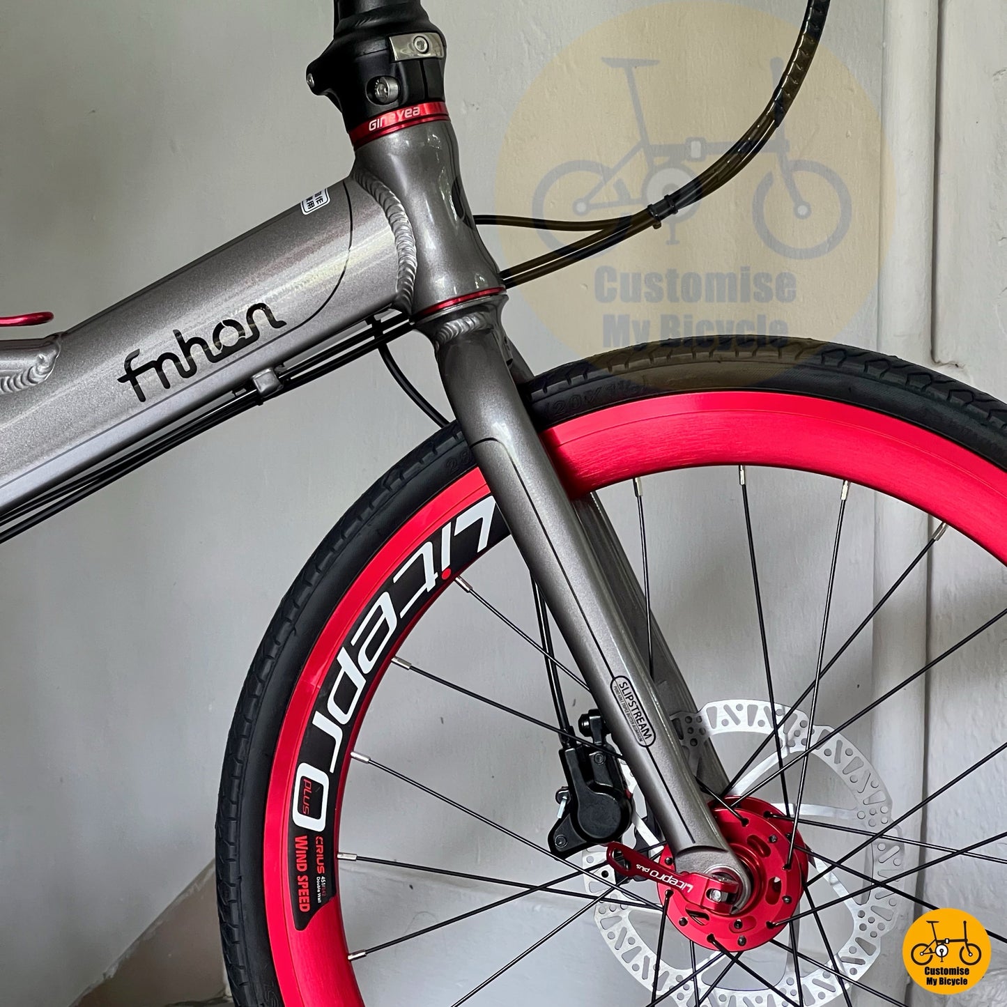 Side view of full bike setup against wall  
