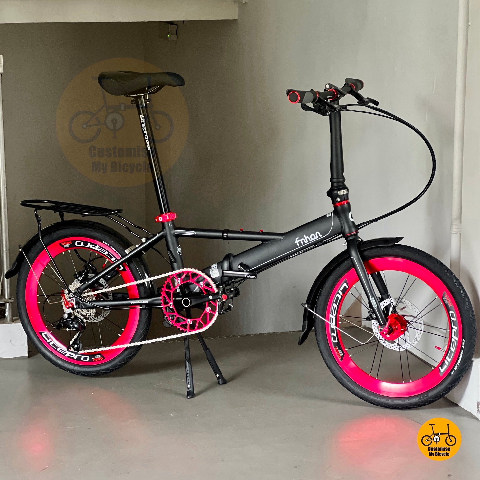 Matte black foldable bike with rear rack, mudguard and SHIMANO gearset  
