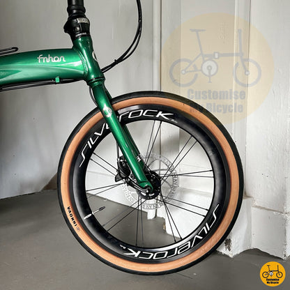 Green frame foldie with brown-themed components for city cycling
