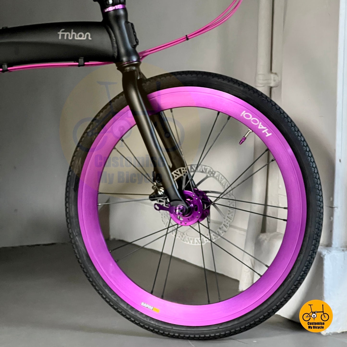 Foldie bike with round bar and purple wire  
