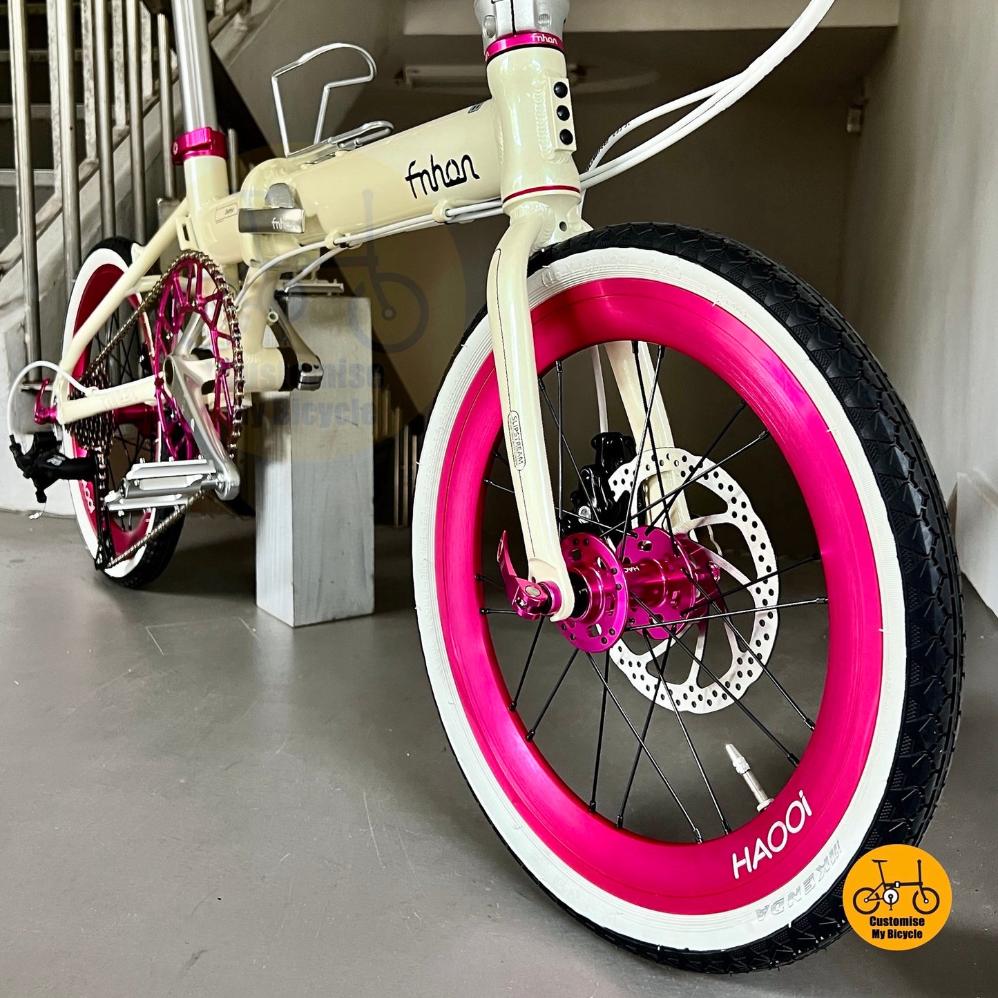 Compact folding bike for women and girls with white tyres and pastel tones  
