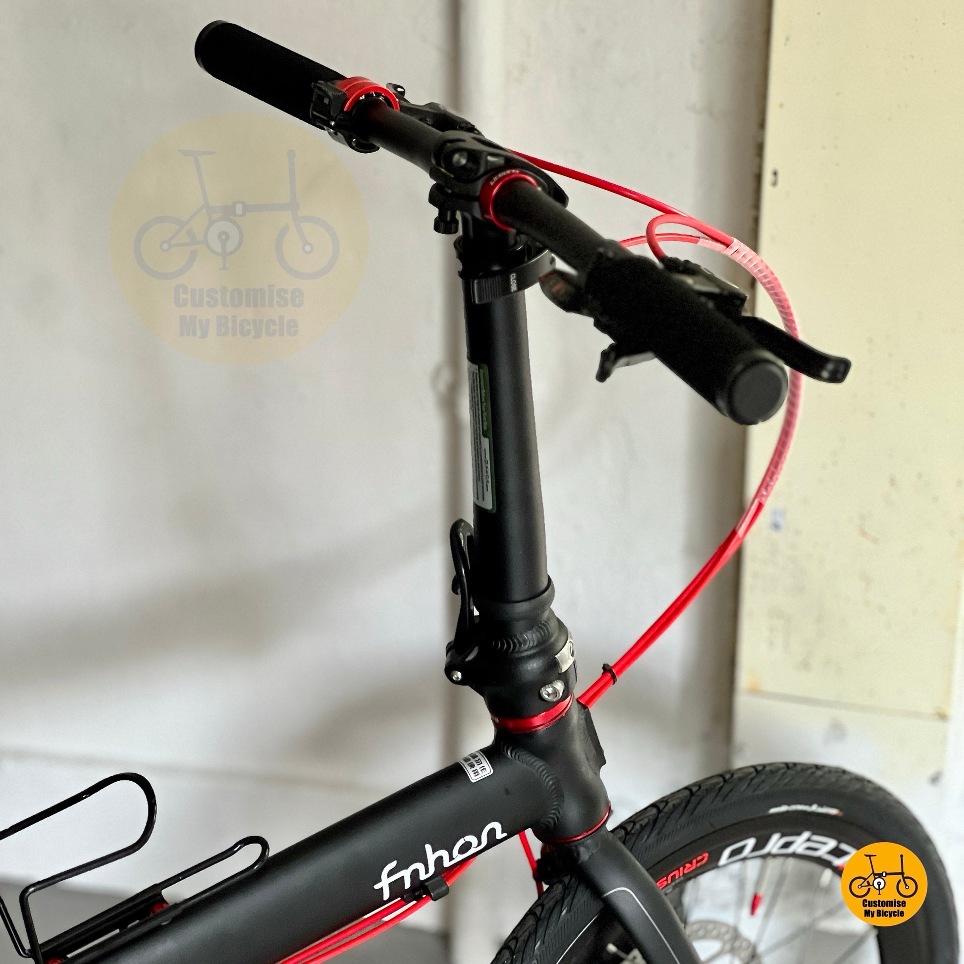 Fnhon Zephyr matte black folding bike with red accent cable details
